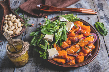 roasted pumpkin slices, spinach leaves, Camembert brie cheese, cashews, sauce. vegetarian salad ,dish