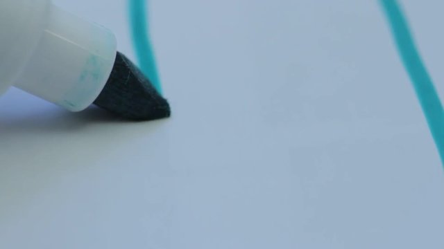 marker draws a line on paper, close-up
