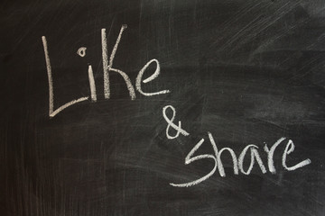 Obraz premium Like and share written on blackboard