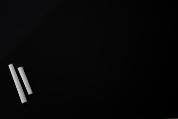 Clean blackboard and white chalk