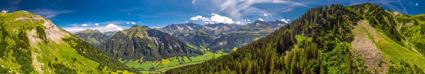Naklejka na ściany i meble Aerial view of Elm village and Swiss mountains - Piz Segnas, Piz Sardona, Laaxer Stockli from Ampachli, Glarus, Switzerland, Europe