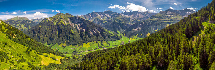 Aerial view of Elm village and Swiss mountains - Piz Segnas, Piz Sardona, Laaxer Stockli from Ampachli, Glarus, Switzerland, Europe