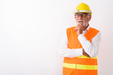Studio shot of handsome senior bearded man construction worker t
