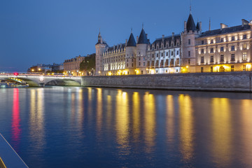 Beautiful view of Seine and Conciergerie at night in Paris, France