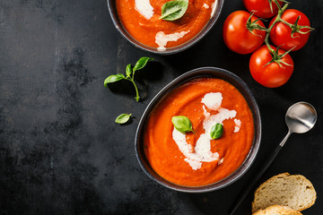 Creamy tomato soup served in bowl