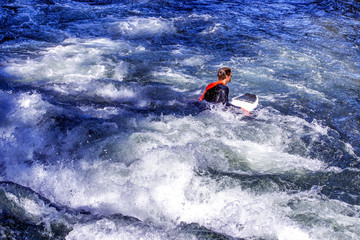 Surfer riding on wave in sea, ocean on sunny day.