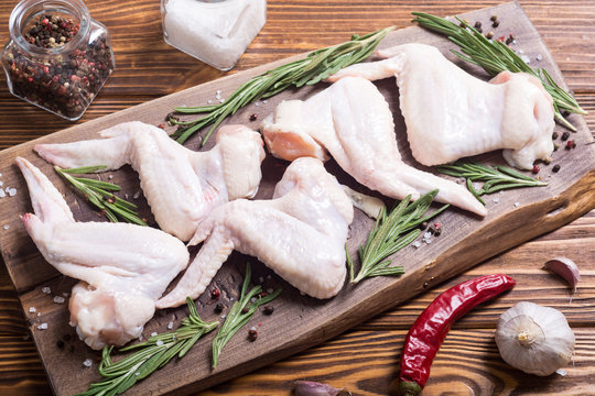 Chicken raw wings with rosemary , garlic , pepper and salt