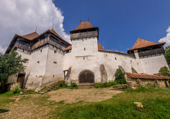 Fototapeta na wymiar Summer view of UNESCO medieval fortified church of Viscri Romania