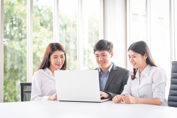 Fototapeta na wymiar Young Asian business people using laptop