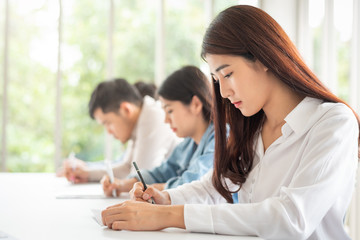 woman sitting in a row having a test in paper © interstid
