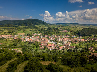 Fototapeta na wymiar Aerial view of Saschiz Szaszkezd castle and medieval Saxon village in Transylvania Romania