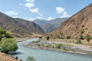 Fototapeta na wymiar Along the road to Taldyk Mountain Pass in Kyrgyzstan taken in August 2018