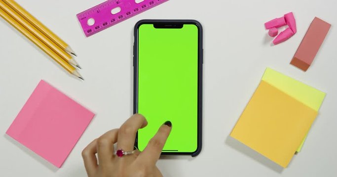 Using a green screen phone on a white work arts and crafts desk