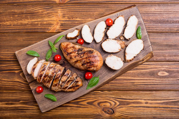 Grilled chicken breast ( fillet ) with basil and tomatoes