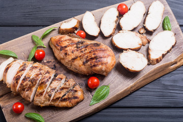 Grilled chicken breast ( fillet ) with basil and tomatoes