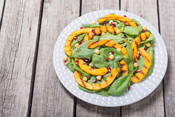Autumn salad with pumpkin , spinach , pomegranate and chickpea