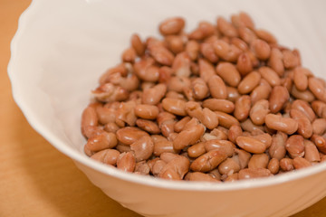 Red boiled beans. Beans in a white plate. Red beans close-up.