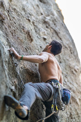 The last movements to reach the summit by a male climber. Rock climbing inside Andes mountains and valleys at Cajon del Maipo, an amazing place to enjoy rock climbing and mountaineering sports, Chile

