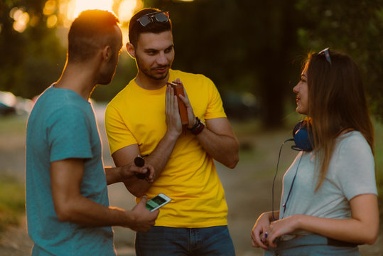 Three Freinds Having A Chat About A Book.