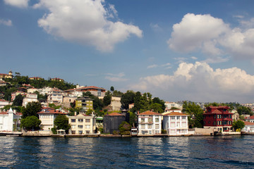 Fototapeta na wymiar View of historical, old Turkish / Ottoman houses by Bosphorus on Asian side of Istanbul. It is a sunny summer day.
