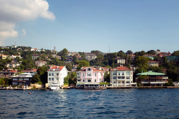 View of houses and buildings by Bosphorus on the Asian side of Istanbul. It is a sunny summer day.