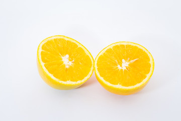 Some oranges in a basket on wooden background.
