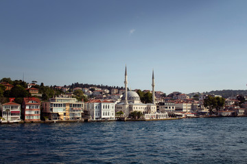 Fototapeta na wymiar View of houses, mosque and buildings by Bosphorus on the Asian side of Istanbul. It is a sunny summer day.