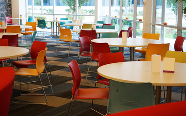 tables and chairs in the cafeteria of the company