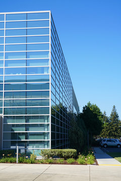 close up on modern company building exterior with blue glass