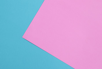 Blue and pink pastel color papers geometric flat laying.