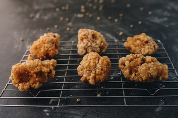 Chicken karaage japanese food in the tray on grey concrete background with herb and flour