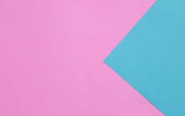 Blue and pink pastel color papers geometric flat laying.
