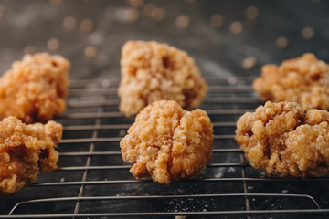 Chicken karaage japanese food in the tray on grey concrete background with herb and flour