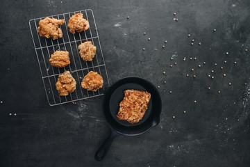 Chicken karaage japanese food in the tray on grey concrete background with herb and flour