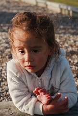 Child's experiences, sadness. The little girl looks thoughtfully in front of her.