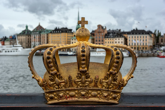 Swedish royal crown with Stockholm Old town on the background.