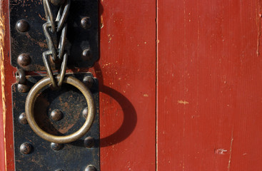 Iron handle with ring on an antique door close-up
