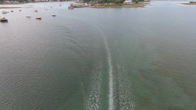 Drone footage of a boat motoring out of the harbor.