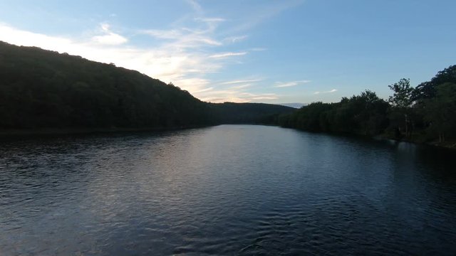 Drone footage of a river late in the day.