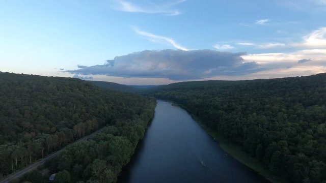 Delaware River shot from above. Aerial view of water, clouds, and mountains.