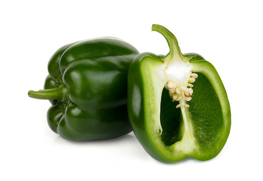whole and half green bell pepper isolated on white background