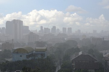 Heavy rain in day time with sunlight that can still can see blue sky and white clouds in the...