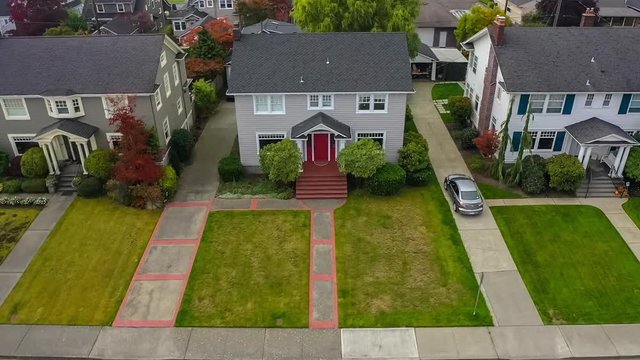 Aerial high-speed approach of an American colonial style suburban home with tiny planet effect