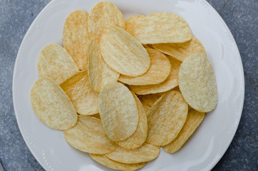 Fried Potato Chips In White Ceramic Plate.