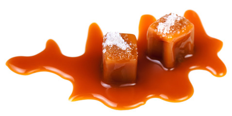 Salted caramel pieces isolated on white background. Homemade  Golden Butterscotch toffee candy close up.