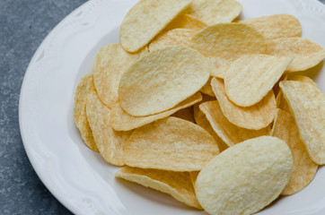 Fried Potato Chips In White Ceramic Plate.