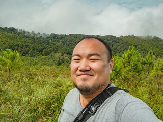 Selfie Photo of asian fat trekker on Khao Luang mountain in Ramkhamhaeng National Park,Sukhothai province Thailand