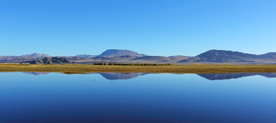 Reflection of lake after beautiful mountain with blue sky of Western Mongolia. Natural background	