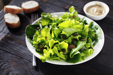 Bowl fresh green lettuce various lettuce leaves wooden table