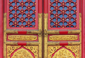 Obraz premium Ornate red wooden door with gold trim and traditional Chinese design in Forbidden City In Beijing China